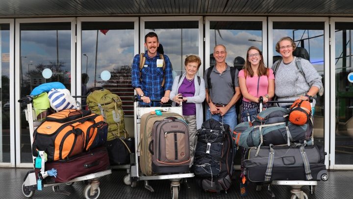 Five Response Volunteers stand infront of the Lilongwe airport with their luggage