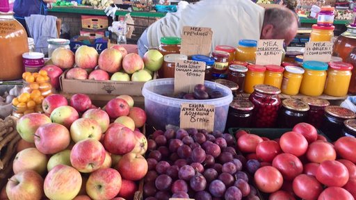 Apples, honey, plums, and other goods for sale at the bazaar.