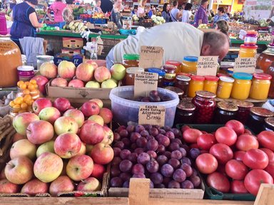 Apples, honey, plums, and other goods for sale at the bazaar.