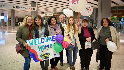 Emily and her community members waiting for the boys' arrival at the airport