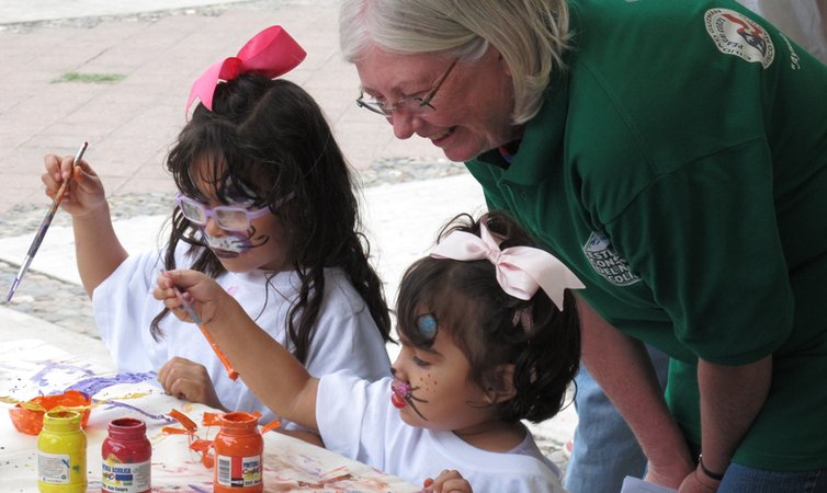 Mary engages a child at an outreach event in Mexico.