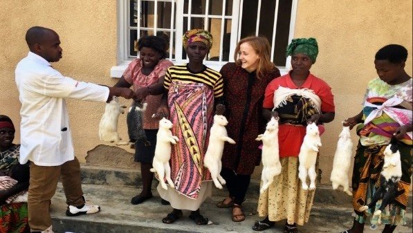 a mothers' group in Rwanda showing off their new rabbits
