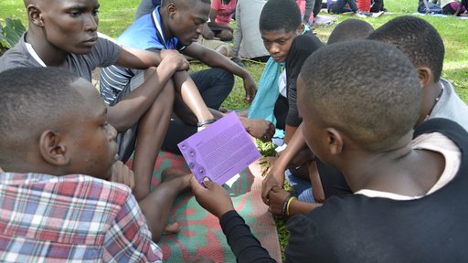 Campers ages 14-19 participating in a gender-based violence story telling and decision-making activity.