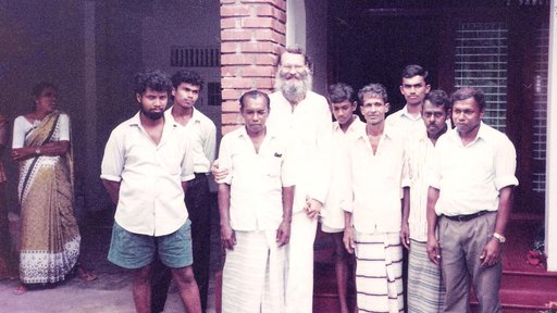 RPCV Craig standing in line with his host brother and villagers