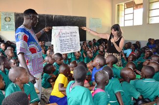 DCM & PC Staff reads out a big book for pupils.JPG