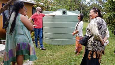 PC Volunteer and staff member visit site of a new water tank with US-AID representative, visits site of a new