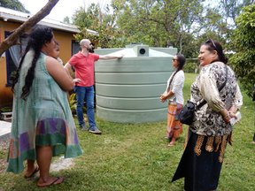 PC Volunteer and staff member visit site of a new water tank with US-AID representative, visits site of a new