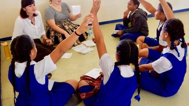 Newly-arrived PC Trainees practice using Sight Word Books at a PC school