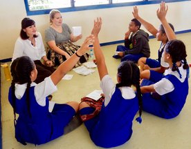Newly-arrived PC Trainees practice using Sight Word Books at a PC school