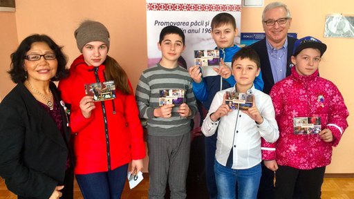 Older American man and woman with Moldovan students.
