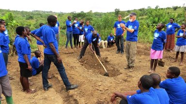 Peace Corps Volunteers David McHolland teaching permagarden digging to the Blue House girls_edited.jpg