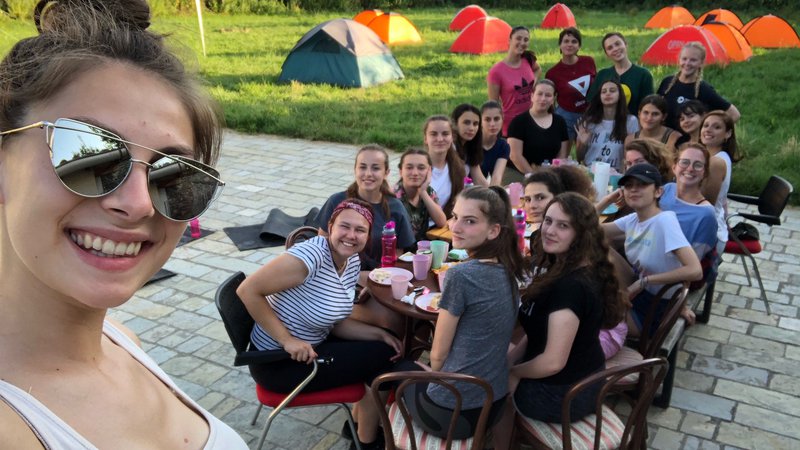Participants and camp staff hold a group dinner on the last night of camp
