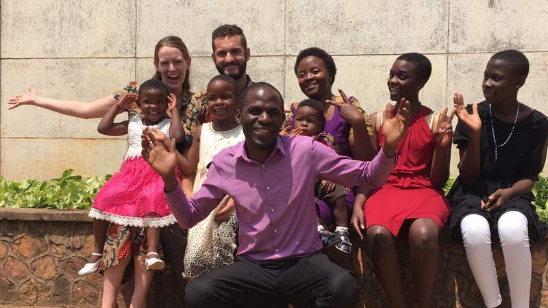 Education PCVs Sophie Fitzsimmons-Peters and Anton Schneider pose for a photo at a celebration with their host family in Uganda.