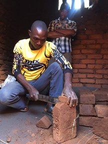 Justin observing cookstove building