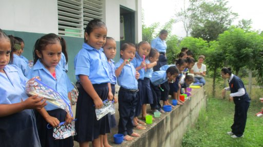 School children brushing their teeth