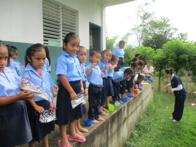 School children brushing their teeth