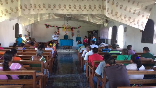 Latrine Project Committee member sharing at church what they learnt at training