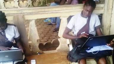 The girls coding at a farming store which provided them with a generator because power was out.