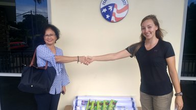 Taylor C receiving donation from IWG