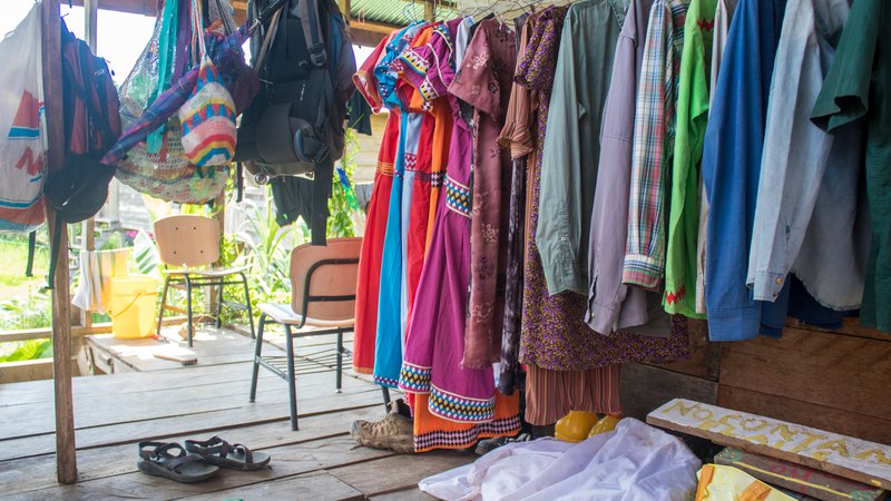 Colorful dresses hang on a line.