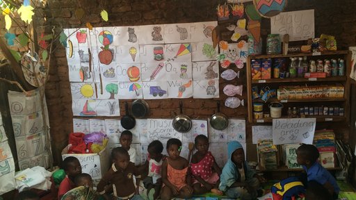 A nursery school classroom transformed using lessons learned from the Perivoli Schools Trust approach. Previously, this classroom was an empty thatch shack. Now, it's filled with activities and learning aids aimed at young children.