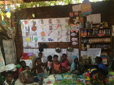 A nursery school classroom transformed using lessons learned from the Perivoli Schools Trust approach. Previously, this classroom was an empty thatch shack. Now, it's filled with activities and learning aids aimed at young children.
