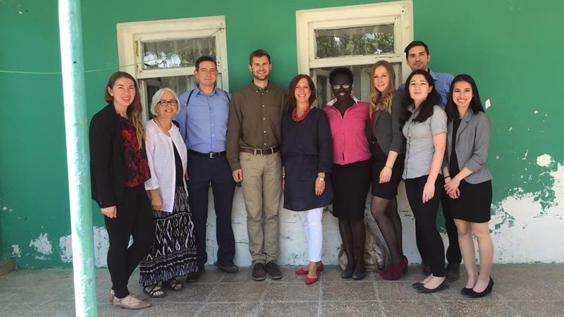 American Peace Corps volunteers stand in a line and smile during a training.