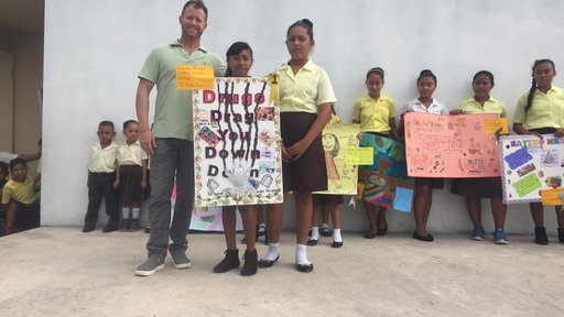 PCV Josh with students presenting poster