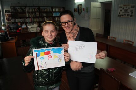 Local youth Cristina participates in an art hour, drawing pictures to share with Americans about Moldova.