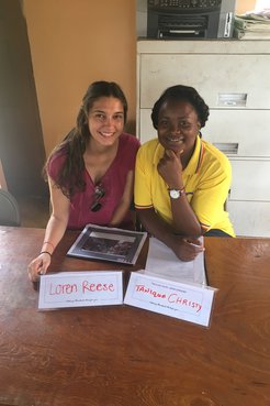 Loren Reese and a Jamaican community counterpart pose with their name plates.