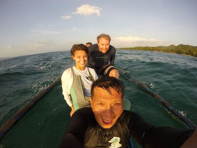 Morgan travels by boat to perform surveys of the local marine protected areas, with her coworkers Drew Sullivan (back, fellow Peace Corps Volunteer) and Romeo Pugoy Jr. (front).