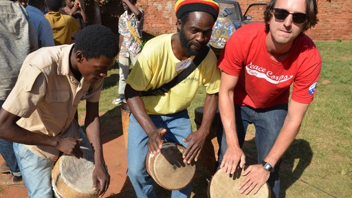 Joe drums with two Malawian friends at Malawi Music Project camp.