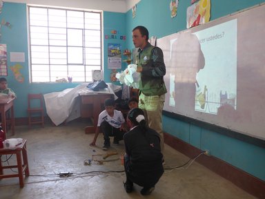 Teaching primary school students about trash management.