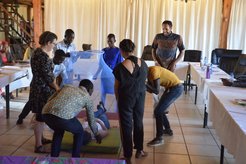 Volunteers and Counterparts participate in a Stomp Out Malaria bootcamp