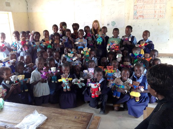 A Peace Corps Zambia Volunteer and her second grade class pose for a photo.