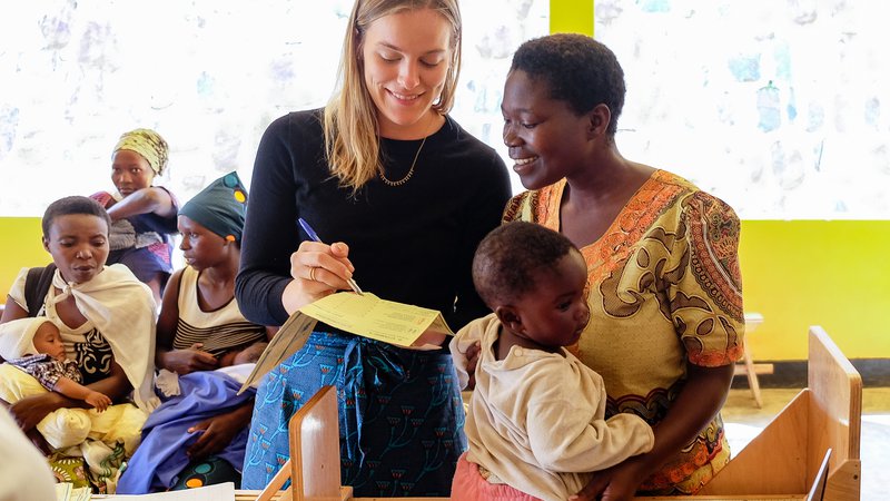 PCV Grace shows a mother the growth data collected for the baby