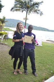 Volunteer Katie Fox awards a certificate to a camp participant.