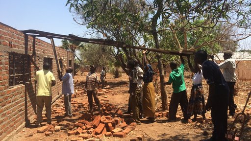 Volunteers put the roof onto our HIV treatment center