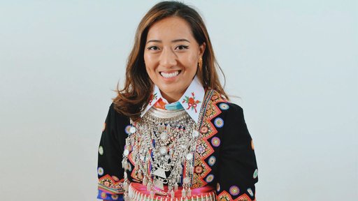 Volunteer is in her traditional clothing of the Hmong people.