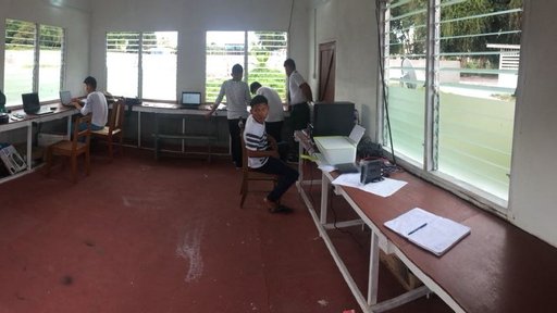 Students and the Hub Technician, Chaission Harris, working on school assignments near the term end.