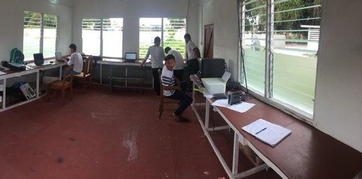 Students and the Hub Technician, Chaission Harris, working on school assignments near the term end.