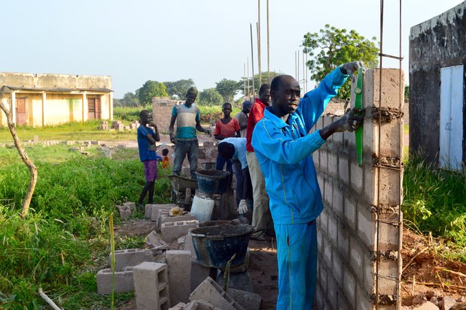 The head mason, Mortalla Diop, constructing the wall.jpg