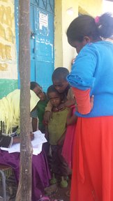 Children receive their trachoma prophylaxis medications at the annual trachoma campaign.