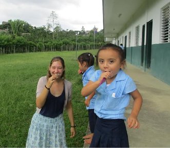 PCV Megan with child brushing their teeth.