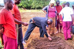Mr. Benedict demonstrates how to sow seeds in a PermaGarden vegetable bed