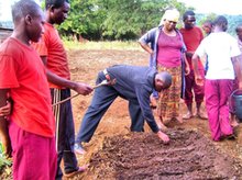 Mr. Benedict demonstrates how to sow seeds in a PermaGarden vegetable bed