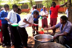 Serving vegatables to the students