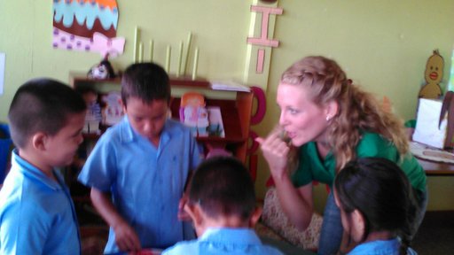 PCV Emily and children working to fill buckets