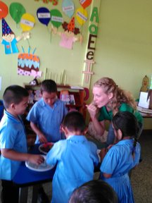 PCV Emily and children working to fill buckets