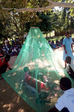 A bed net hanging demo led by Samuel